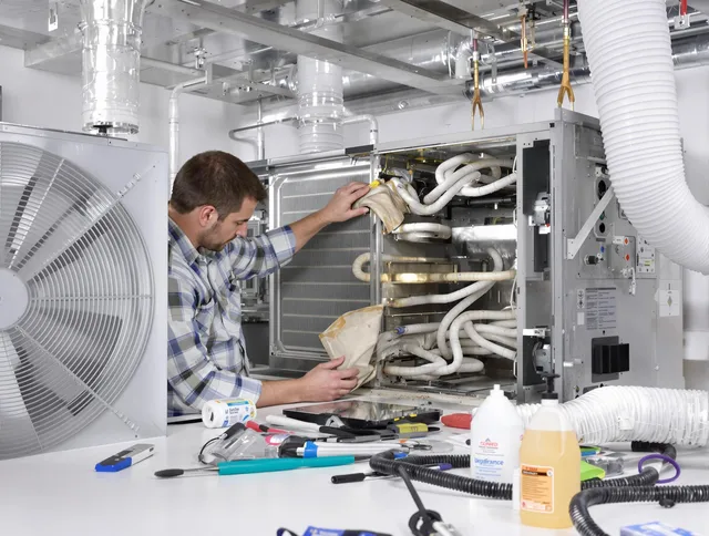Millbury Air Duct Cleaning specialist performing precision AC coil cleaning in Millbury