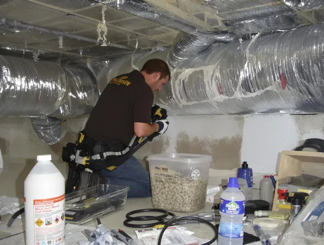 Millbury Air Duct Cleaning specialist performing professional mold removal from air ducts in Millbury