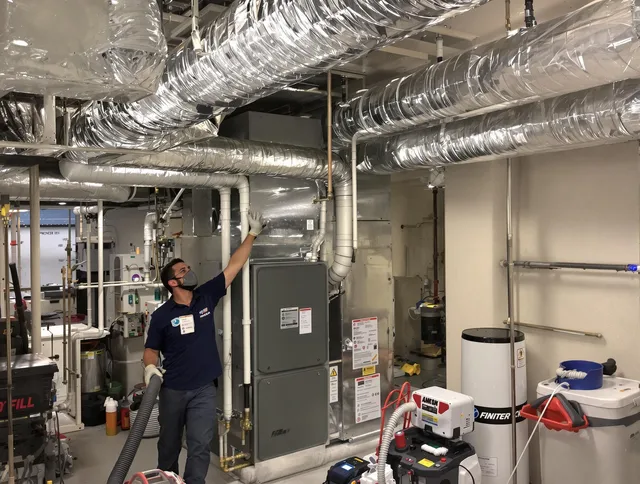 Millbury Air Duct Cleaning specialist performing thorough furnace duct cleaning in a Millbury residence