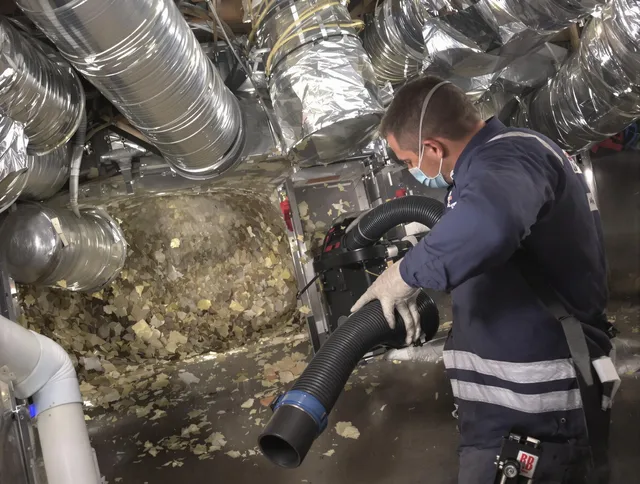 Millbury Air Duct Cleaning specialist operating negative pressure cleaning equipment for thorough duct maintenance in Millbury