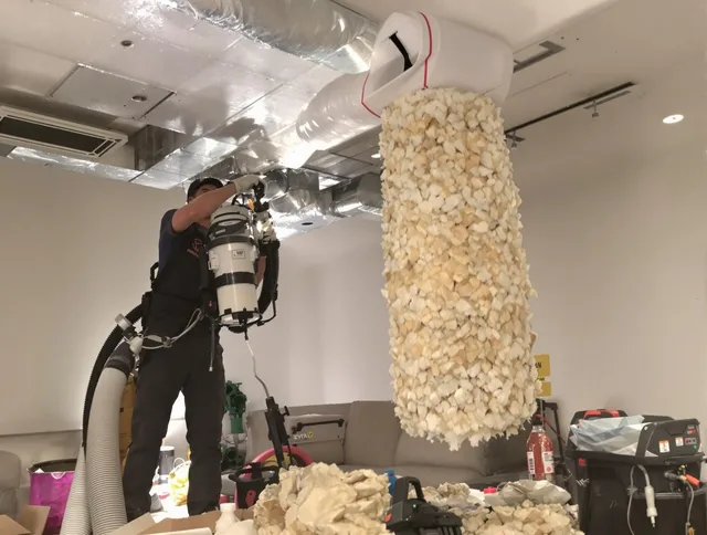 Millbury Air Duct Cleaning technician performing precision vacuum insulation removal in a residential property in Millbury